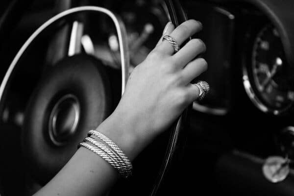 Fei Fei Sun driving a car wearing David Yurman Sculpted Cable jewelry.