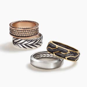 Four David Yurman men's band rings in a variety of metals.