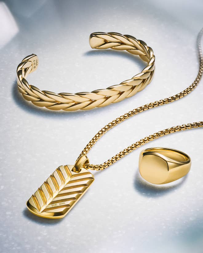 A variety of David Yurman cable bracelets in silver and gold.