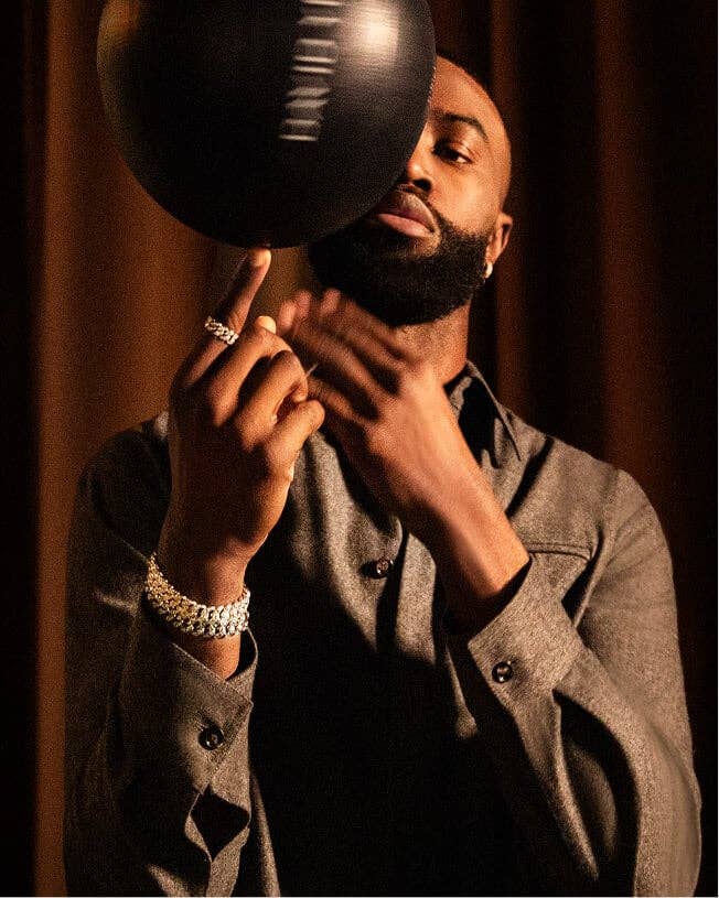 Jaylen Brown spinning a basketball wearing David Yurman jewelry.