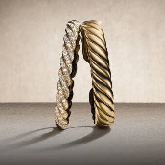 Three David Yurman Sculpted Cable bracelets.