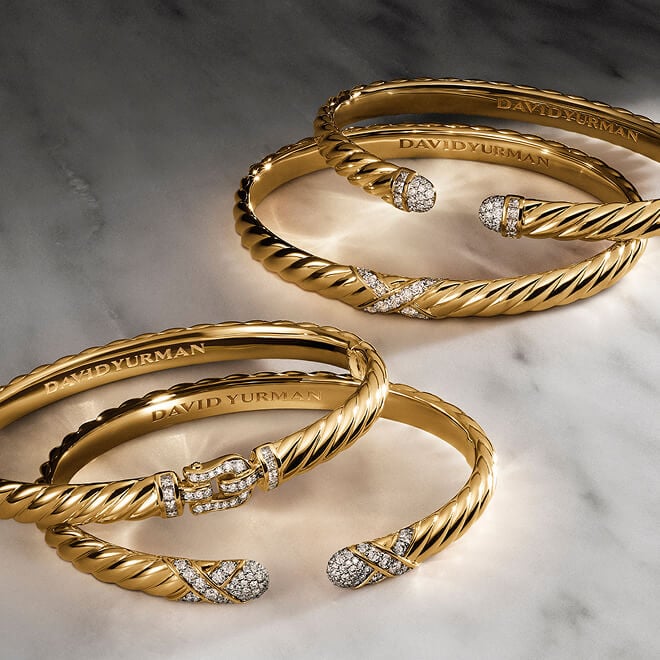 Three David Yurman Sculpted Cable bracelets.