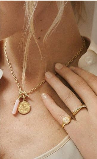 A mother wearing a David Yurman necklace.