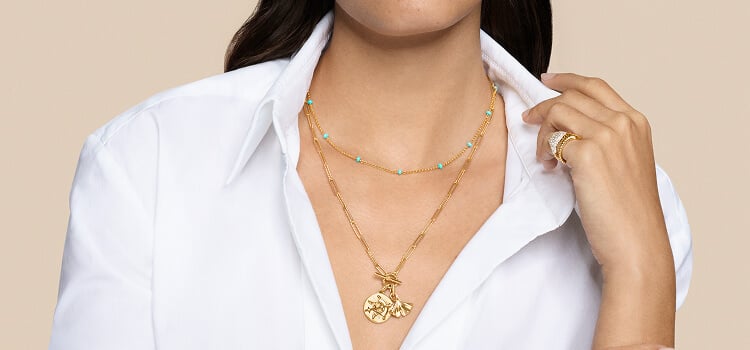 Model wearing David Yurman necklaces.