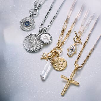 A variety of David Yurman necklaces with amulets, religious pendants and charms.