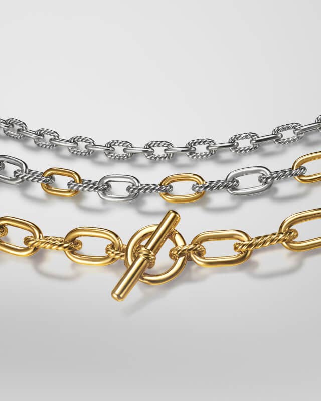 Three David Yurman chains in gold and silver.