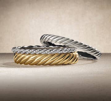 Three David Yurman Sculpted Cable bracelets.