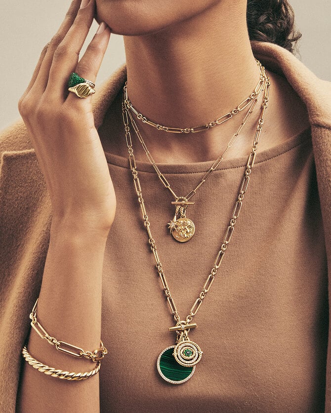 Model wearing David Yurman gold jewelry.
