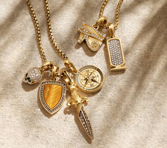 A collection of David Yurman gold pendants.