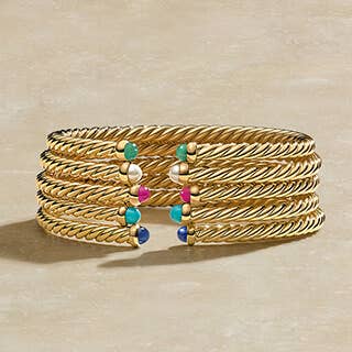 Stack of David Yurman Bracelets in Yellow Gold, with and without diamonds.