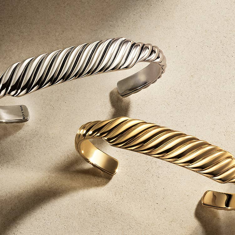 An image of two cable contour bracelet in silver and gold.
