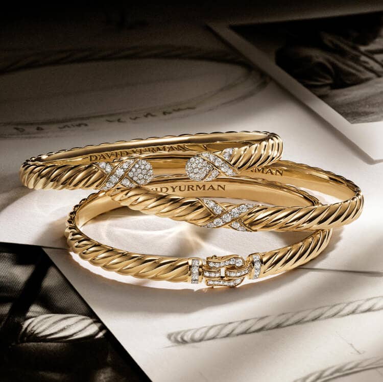 Three David Yurman Sculpted Cable gold bracelets with diamonds. 
