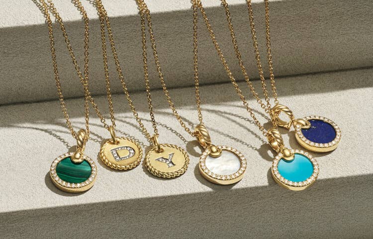 An image of 6 petite gold pendant necklaces.