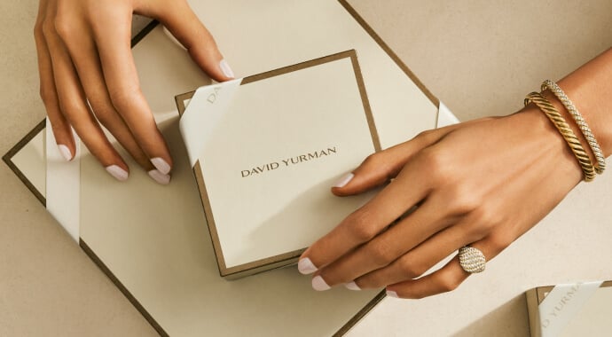 A woman's hands wearing David Yurman jewelry.