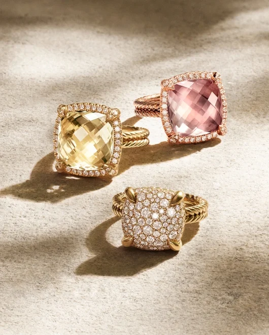 A collection of 3 David Yurman gold rings with varying stones.
