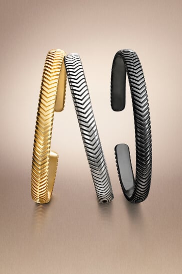 Three David Yurman cuff bracelets for men.