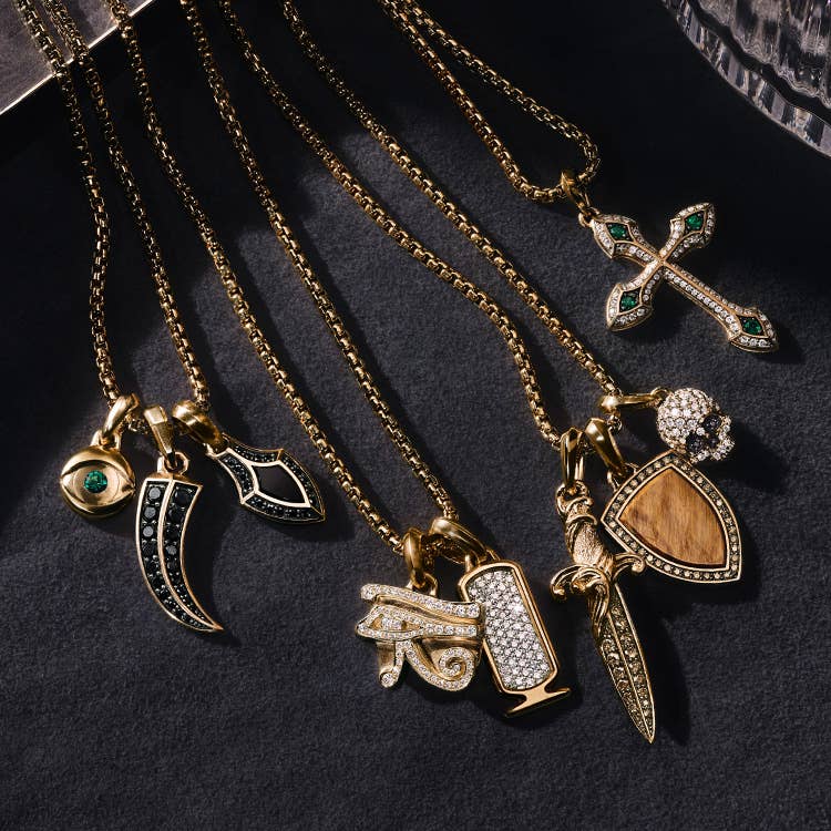 An image of eight amulets in yellow gold.