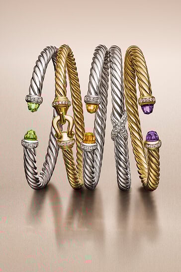 Three David Yurman cuff bracelets for men.