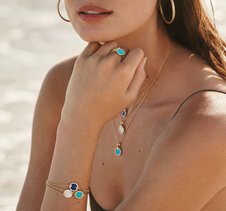 An image of Taylor Hill wearing petite DY Elements necklaces, bracelets and rings.