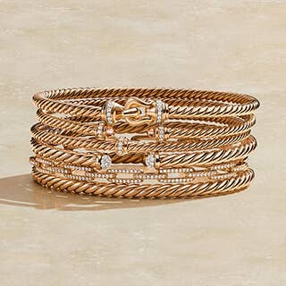 Stack of David Yurman bracelets in Rose Gold. 