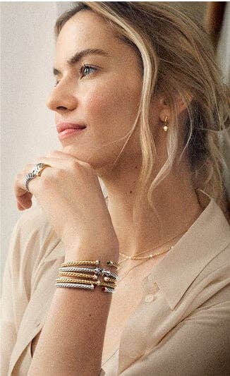 A mother wearing David Yurman jewelry.