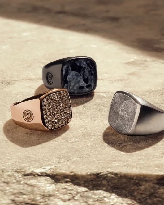 A collection of 3 David Yurman rings with and without stones.