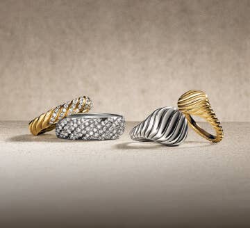 Four David Yurman Sculpted Cable rings.