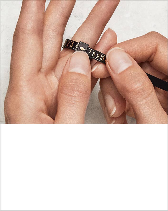 An image of the David Yurman universal ring sizer getting put on a finger.
