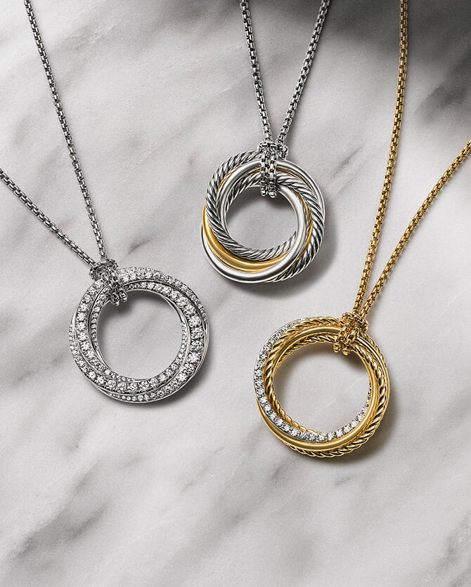 Three David Yurman Crossover pendants in various metals.