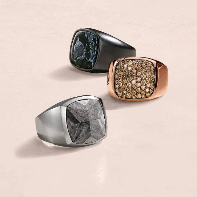 Three David Yurman signet rings. One silver, one rose gold and one blackened silver.