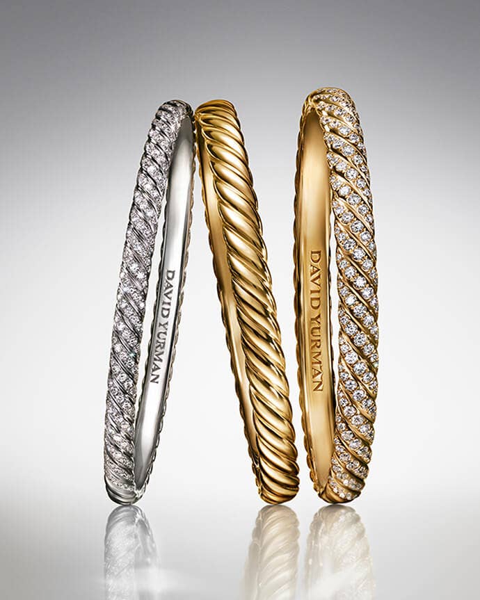 Three David Yurman Sculpted Cable bracelets.