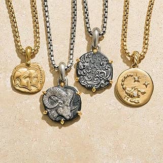 Four David Yurman Amulets in silver and gold featuring Zodiac signs. 