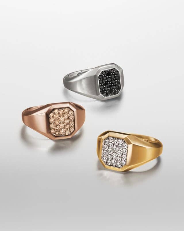 Three David Yurman rings in silver and gold for men.