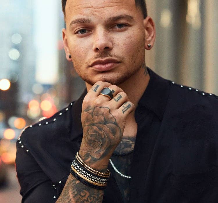 An image of Kane Brown wearing chain bracelets and necklace.