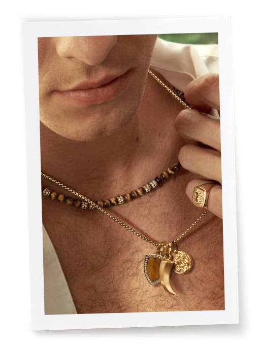 An image of Shawn Mendes wearing David Yurman amulets on a gold chain necklace.