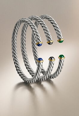 Three David Yurman bracelets.