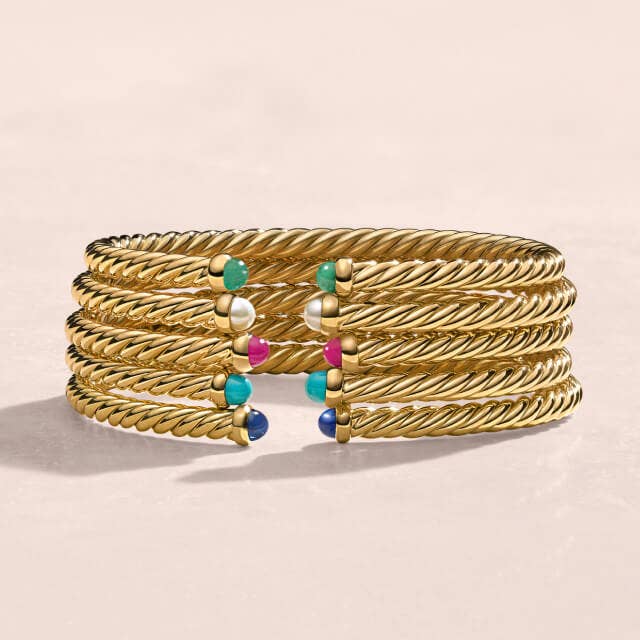 Stack of David Yurman Bracelets in Yellow Gold, with and without diamonds.
