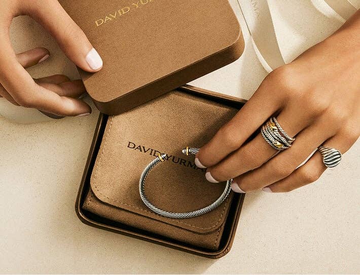 David Yurman bracelet in a gift box with a hand wearing rings.