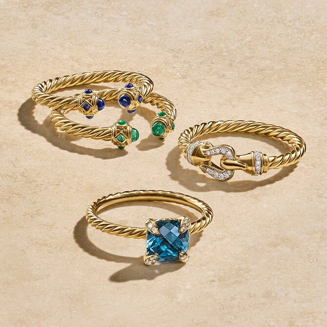 Four David Yurman rings in gold.