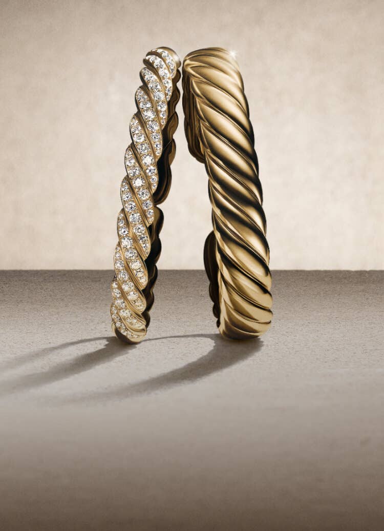 Two David Yurman Sculpted Cable cuff bracelets.