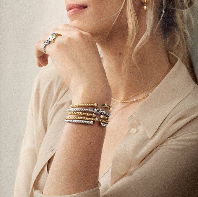 Model Wearing A Mix of David Yurman Gold and Silver Bracelet Cuffs