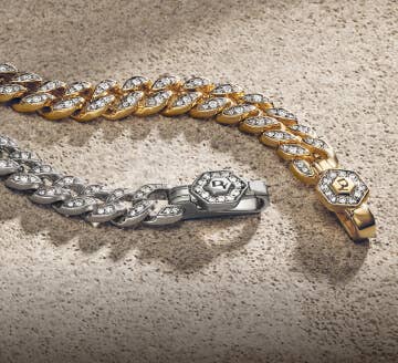 Two women's David Yurman Curb Chain bracelets.