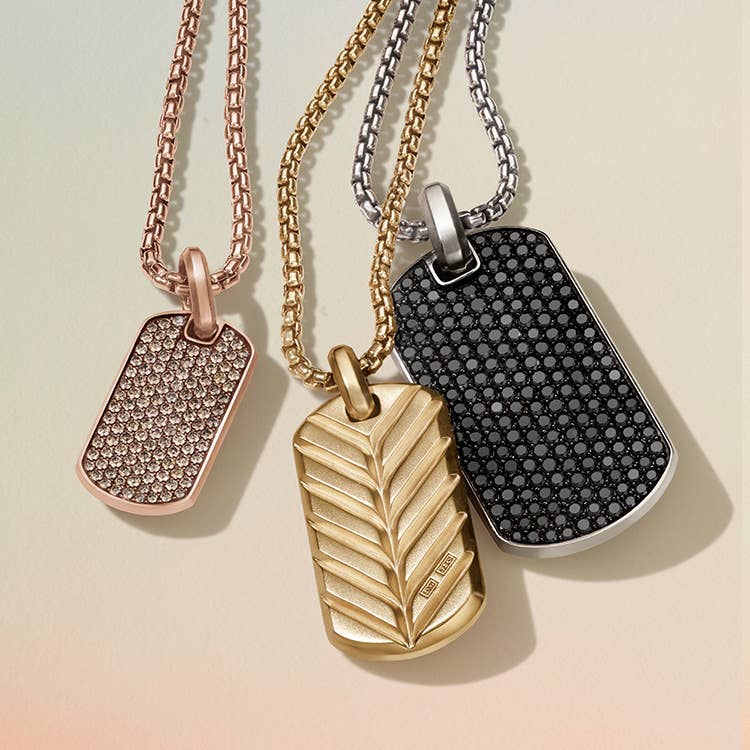 An image of three tags one in 18K rose gold with cognac diamonds, yellow gold and silver with black diamonds.