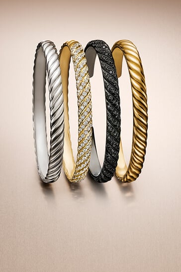 Three David Yurman bracelets.