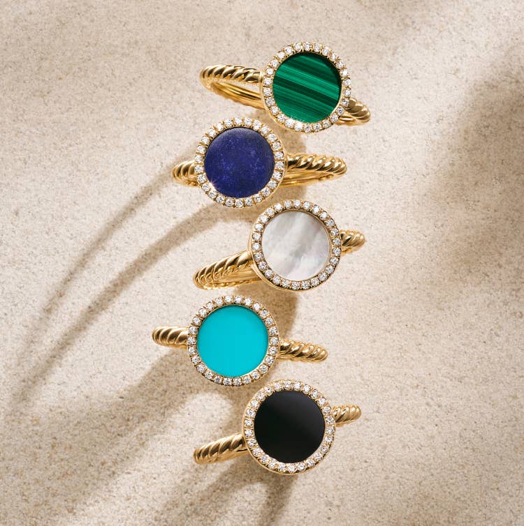 Five petite DY Elements rings in yellow gold.