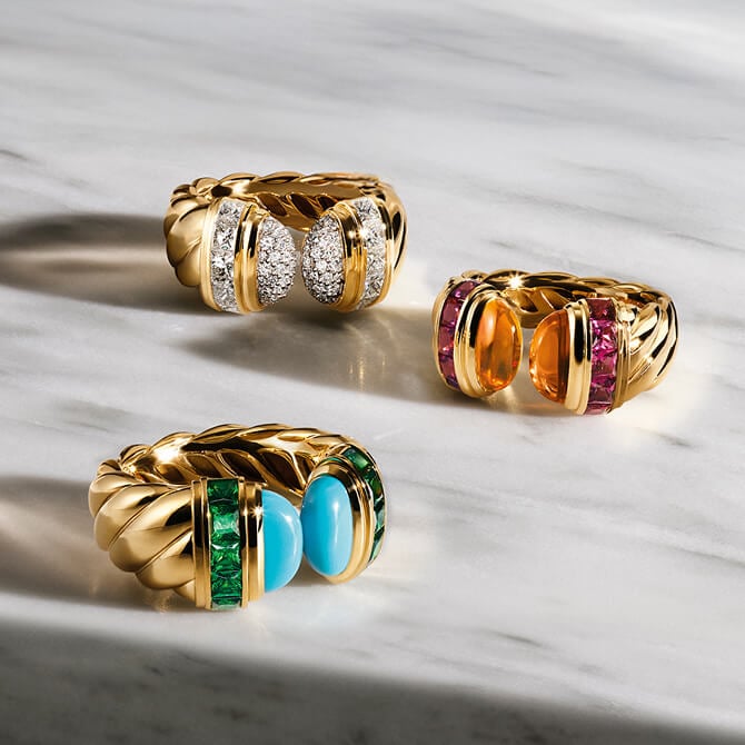 Three David Yurman Sculpted Cable rings in gold.