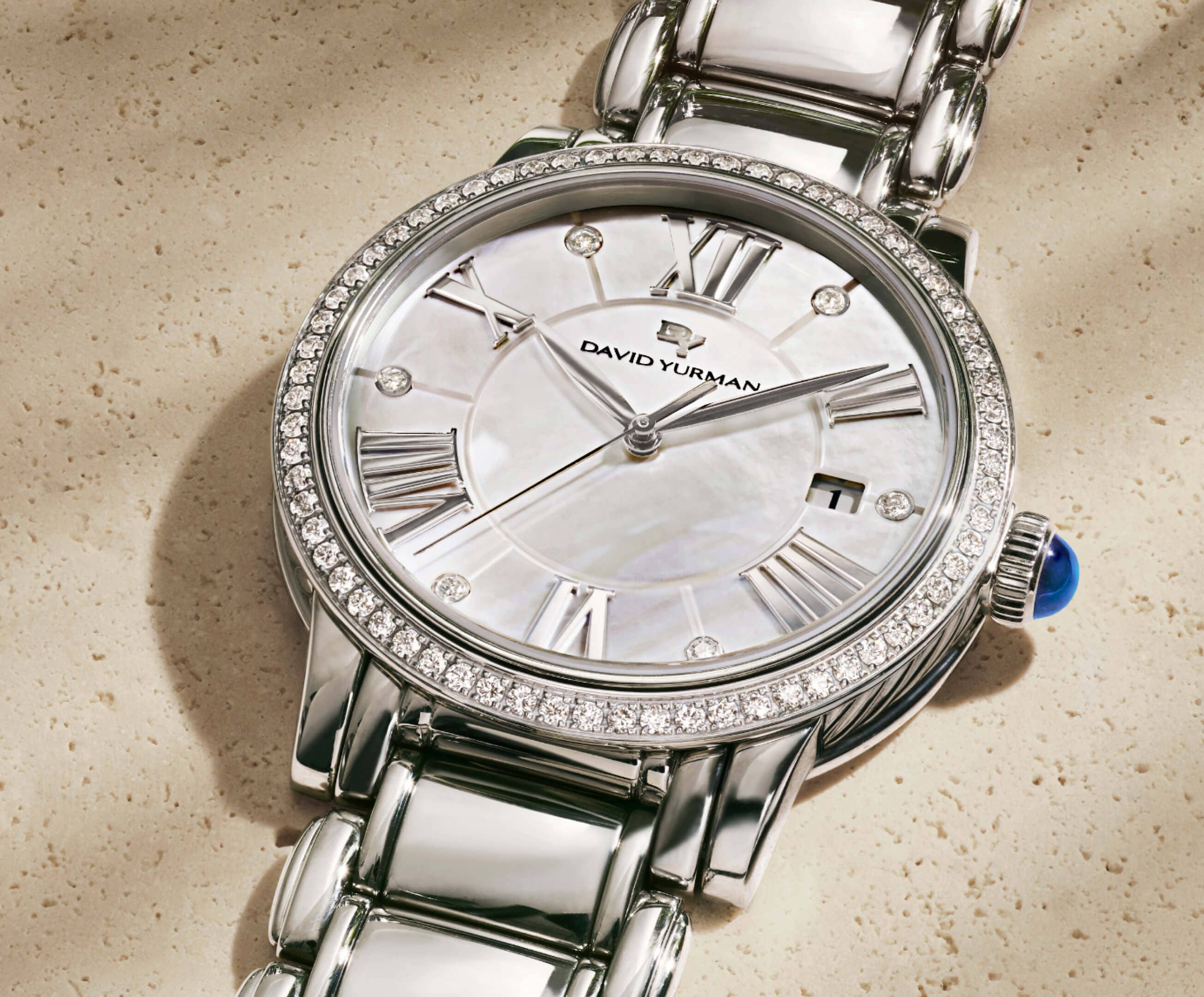 An image of a womens stainless steel watch with diamonds.
