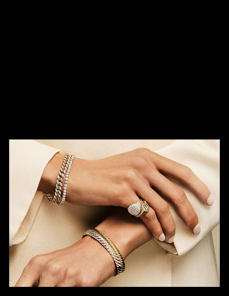 David Yurman bracelets shown stacked on wrists.