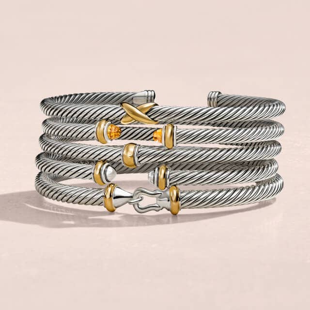 Stack of David Yurman Bracelets with mixed metals.