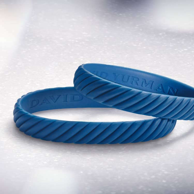 An image of two blue rubber David Yurman bracelets